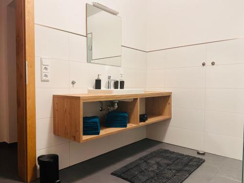 a bathroom with a sink and a mirror at Apartment Span in Fulpmes