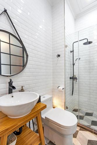 a bathroom with a sink and a toilet and a shower at S Loft Manado in Manado