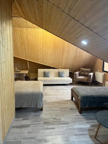 a room with two beds and a couch at Dom Adonis in Dilijan