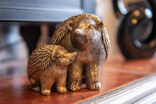 a figurine of two hedgehogs sitting on a table at Characterful 2 bedroom apartment - Central location in Castle Donington