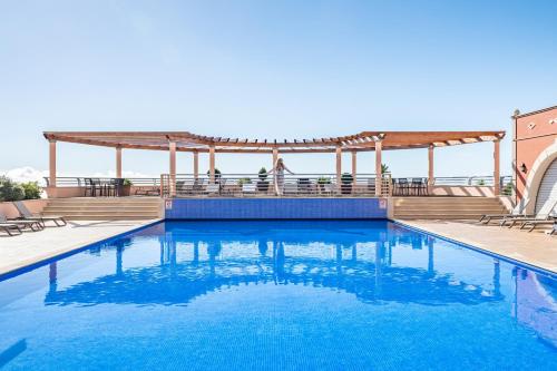 a pool with a gazebo and blue water at Villa Sea Renity - Palheiro Village by ALMA Holiday Rentals in Funchal