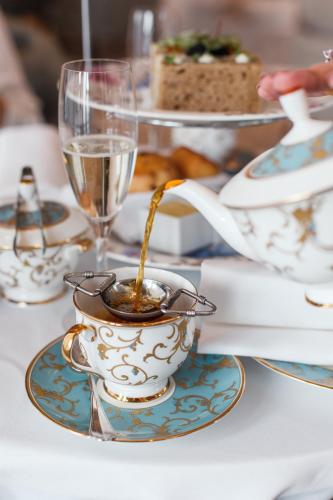 a table with a teacup on a plate with a bowl of food at Four Seasons Hotel Baku in Baku