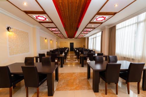 a large room with tables and chairs and windows at Kirovakan Hotel in Vanadzor