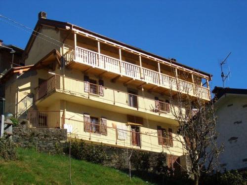 a large building with balconies on the side of it at B&B CA' DEL PITUR CICOGNA in Cossogno