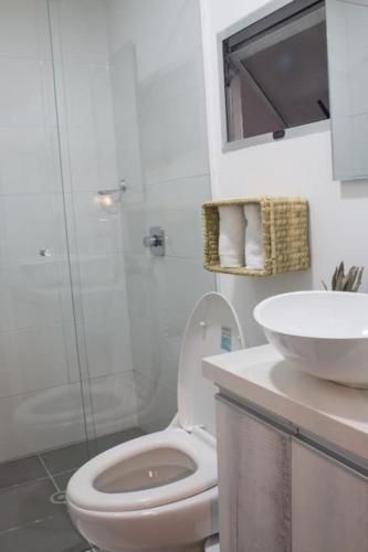 a white bathroom with a toilet and a sink at Espectacular apartaestudio en sabaneta! in Sabaneta