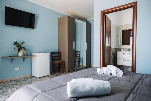 a bedroom with a large bed with a large mirror at Agriturismo Paradiso in Parabita