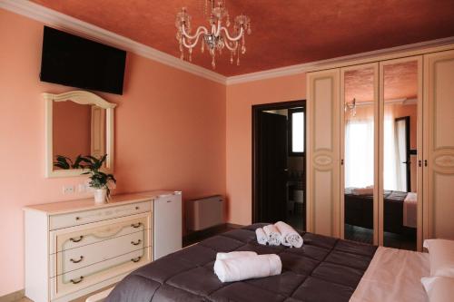 a bedroom with a bed and a dresser and a mirror at Agriturismo Paradiso in Parabita