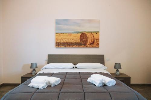 a bedroom with a bed with two towels on it at Agriturismo Paradiso in Parabita