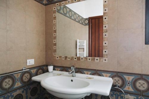 a bathroom with a sink and a mirror at Agriturismo Paradiso in Parabita