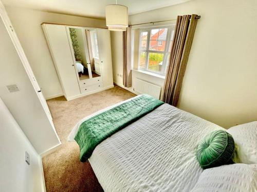 a bedroom with a bed and a large window at Whessoe House by Blue Skies Stays in Stockton-on-Tees