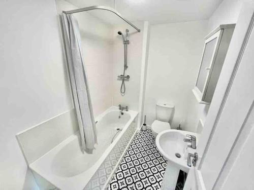 a white bathroom with a shower and a sink at Whessoe House by Blue Skies Stays in Stockton-on-Tees