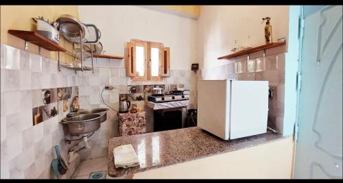 a kitchen with a white refrigerator and a sink at Dahab in Dahab