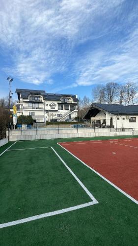a tennis court in front of a building at Casa YDA in Horezu