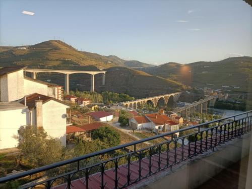 a view of a city with a bridge over a river at CasaMaeDouro in Peso da Régua