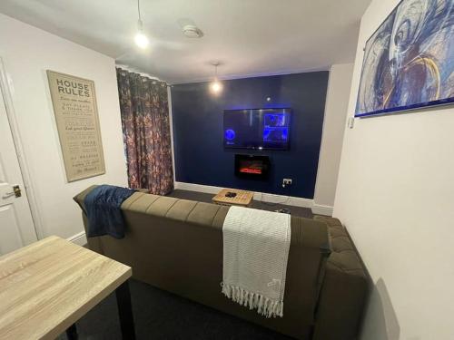 a room with a couch and a tv on a wall at City Escape! Fishponds Apartment, Bristol, sleeps up to 4 guests in Bristol