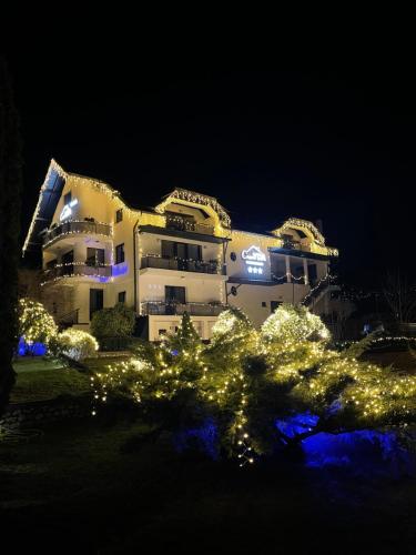 a building with lights in front of it at night at Casa YDA in Horezu