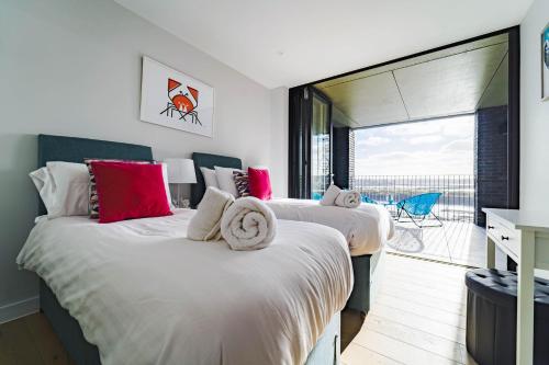 two beds in a room with a balcony at Beach Pad in Hayle