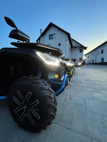 a black car parked in a parking lot at Casa YDA in Horezu