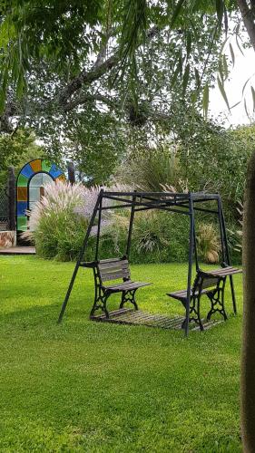 a swing and a bench in a park at Posada del Santo Green & Rest - Cabañas in Salta