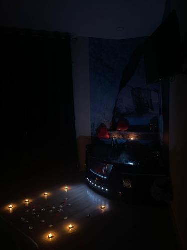 a dark room with a bed with lights on the floor at B&B Eden in Scafati