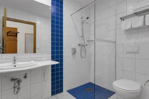 a bathroom with a shower and a toilet and a sink at Aurora Hotel at Reykjavik-Keflavik Airport Terminal KEF in Keflavík