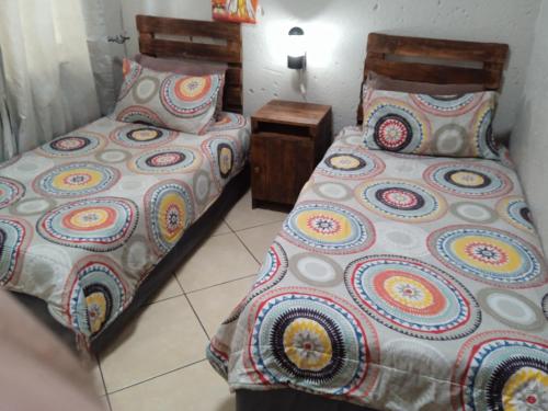 two beds sitting next to each other in a room at Bellamia in Marloth Park