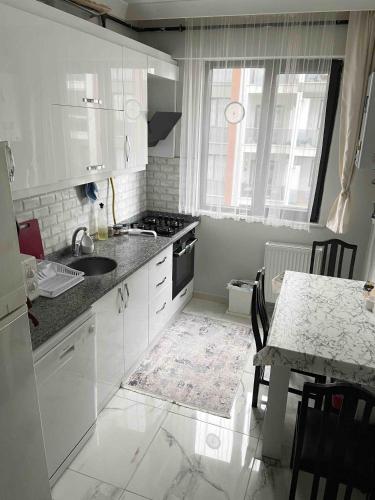 a white kitchen with a sink and a table at Private Room in Istanbul #36 in Istanbul