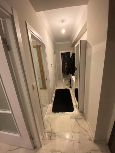 a hallway with a black rug in a white room at Private Room in Istanbul #36 in Istanbul