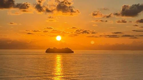 a cruise ship in the ocean at sunset at Stunning penthouse, 2 bedroom, heart of Sliema in Sliema