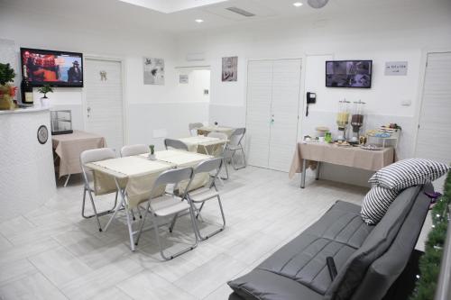 a room with tables and chairs and a kitchen at Albergo Casablanca in Naples
