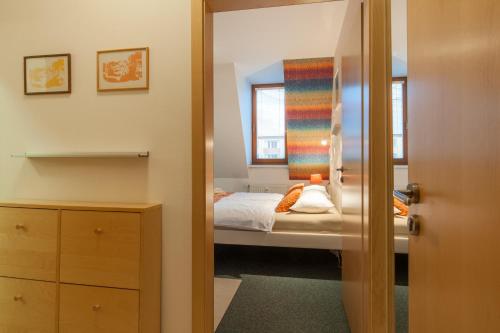 a small bedroom with a bed and a window at apartmány Marco Shipping in České Budějovice