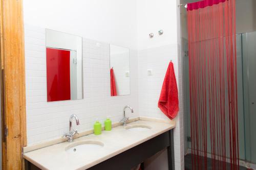 La salle de bains est pourvue de 2 lavabos et d'une douche. dans l'établissement This Is Lisbon Hostel, à Lisbonne