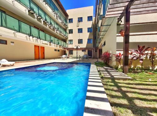a swimming pool in front of a building at Flat Manawa Beach - Porto de Galinhas in Porto De Galinhas
