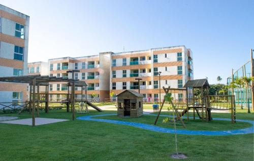 a playground in front of a building at Flat em Porto de Galinhas - Muro Alto Clube in Porto De Galinhas