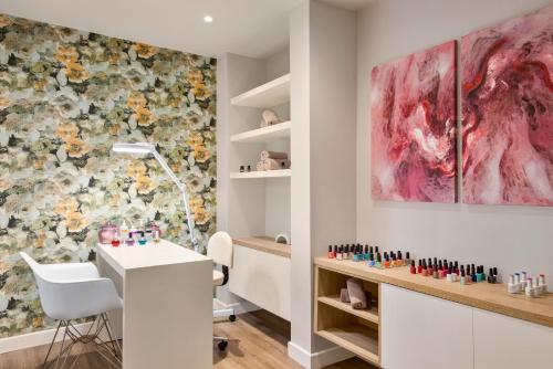 a salon with a white desk and a flower wall at TRYP by Wyndham Corfu Dassia in Dassia