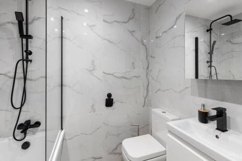 a bathroom with a shower and a toilet and a sink at Star London Vivian Avenue 2-Bed Haven in The Hyde