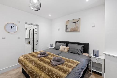 a bedroom with a bed with two pillows on it at Star London Vivian Avenue 2-Bed Retreat with Garden in The Hyde