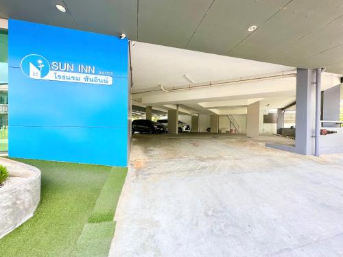 an empty parking garage with a sign in front of it at Sun Inn in Songkhla