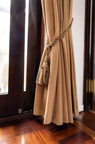 a curtain on a door next to a window at Cape Village Lodge in Durbanville