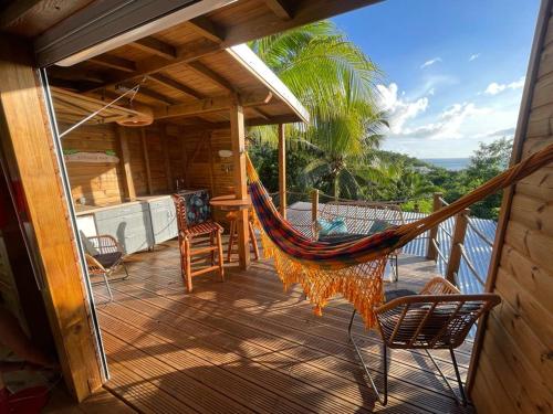 a hammock on the deck of a house at KAZAKOLIBRI in Gourbeyre