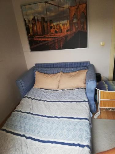 a bed with a blue couch in a room at Private Room in Istanbul #44 in Tuzla