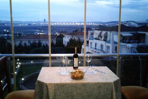 a table with a bottle of wine and two glasses at Private Room in Istanbul #45 in Tuzla