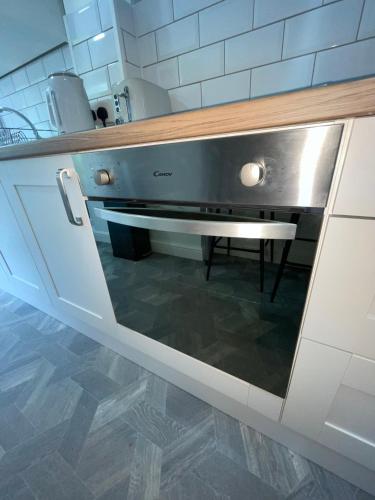 a kitchen with a stainless steel oven in a kitchen at Ryland House Sleeps 8 M6 Access & Garden in Birmingham
