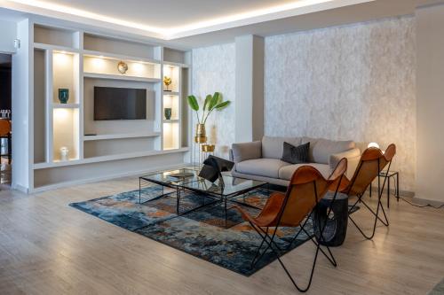 a living room with a couch and a table and chairs at Bossa & Bed Hostel in Lisbon