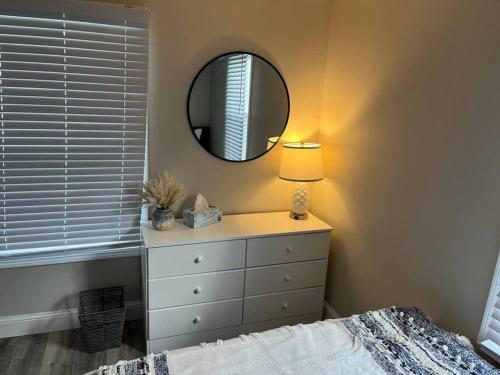 a bedroom with a white dresser and a mirror at Family Beach Fun Spot, Firepit, Games, FireTV in Michigan City
