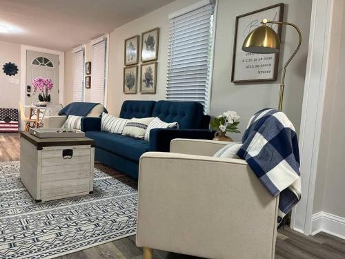 a living room with a blue couch and chairs at Family Beach Fun Spot, Firepit, Games, FireTV in Michigan City