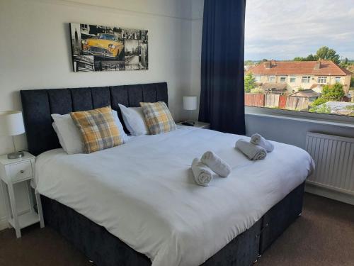 a bedroom with a large bed with towels on it at Mackie House by Cliftonvalley Apartments in Bristol