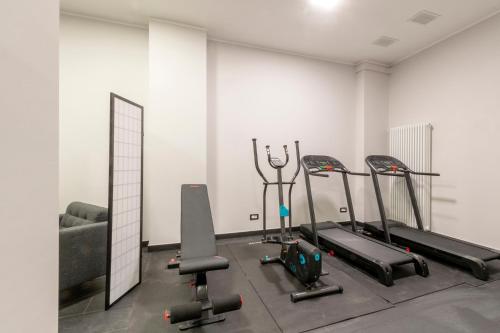 a gym with several tread machines in a room at Centro Storico Caruggi 2min Acquario Pellicceria Superior Loft Palazzo Rolli in Genova