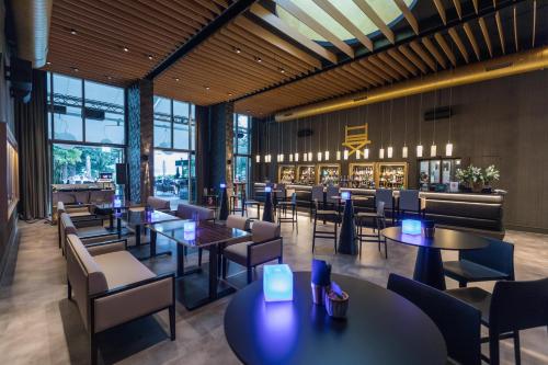 a restaurant with tables and chairs and a bar at Parkhotel Delta, Wellbeing Resort in Ascona