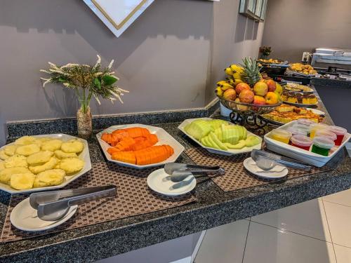 un buffet de frutas y verduras en un mostrador en Hotel Piratininga Fernando Corrêa - Rondonópolis, en Rondonópolis